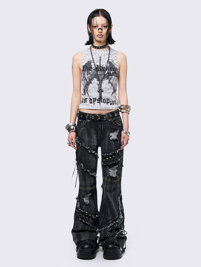 Black washed flare jeans with stud, eyelet, lace-up, and distressed details. Grunge-inspired look.
