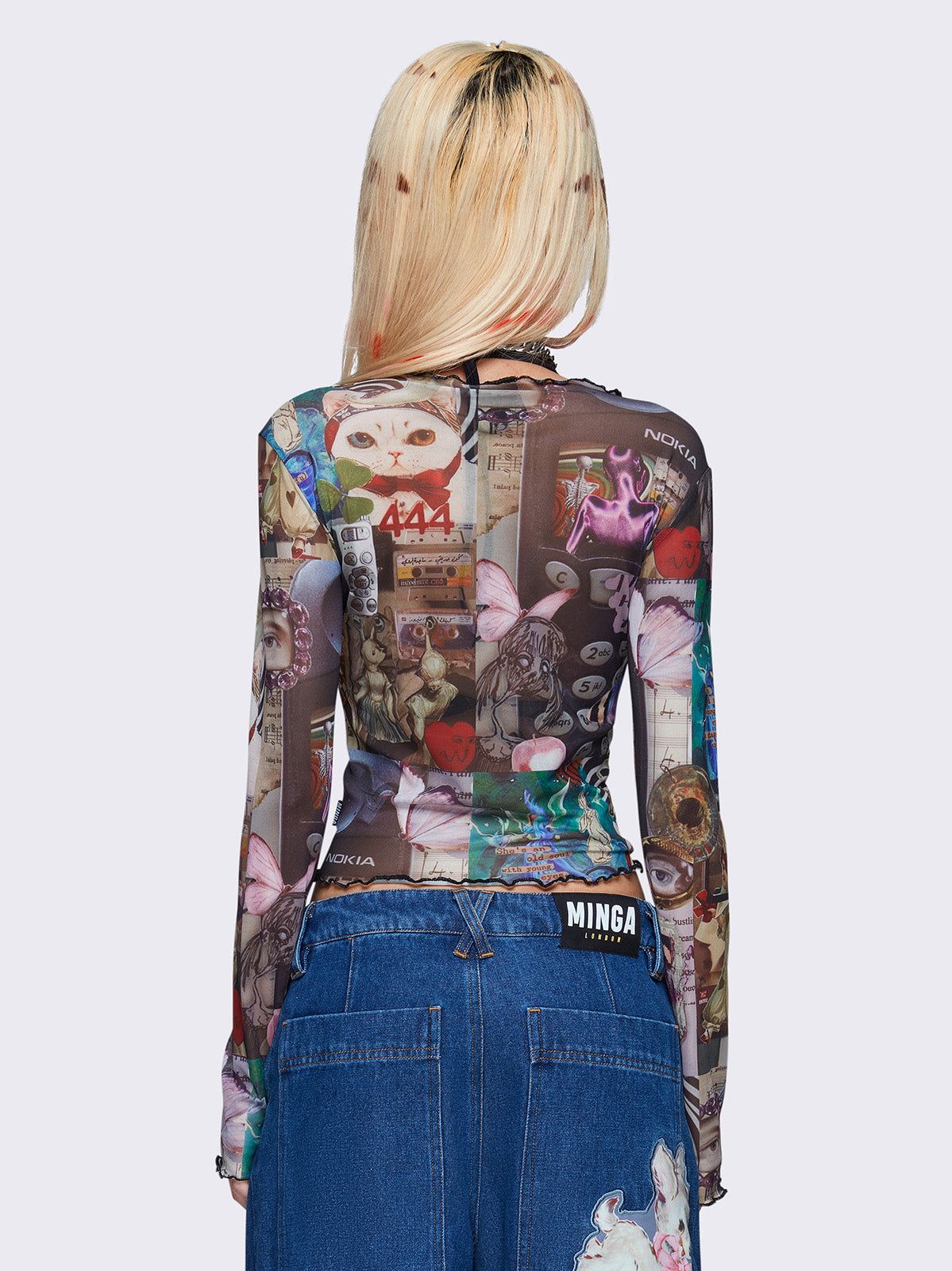 Printed mesh crop top with all over pop art collage graphic print, black lace up details, reverse stitching, and lettuce edge trims.