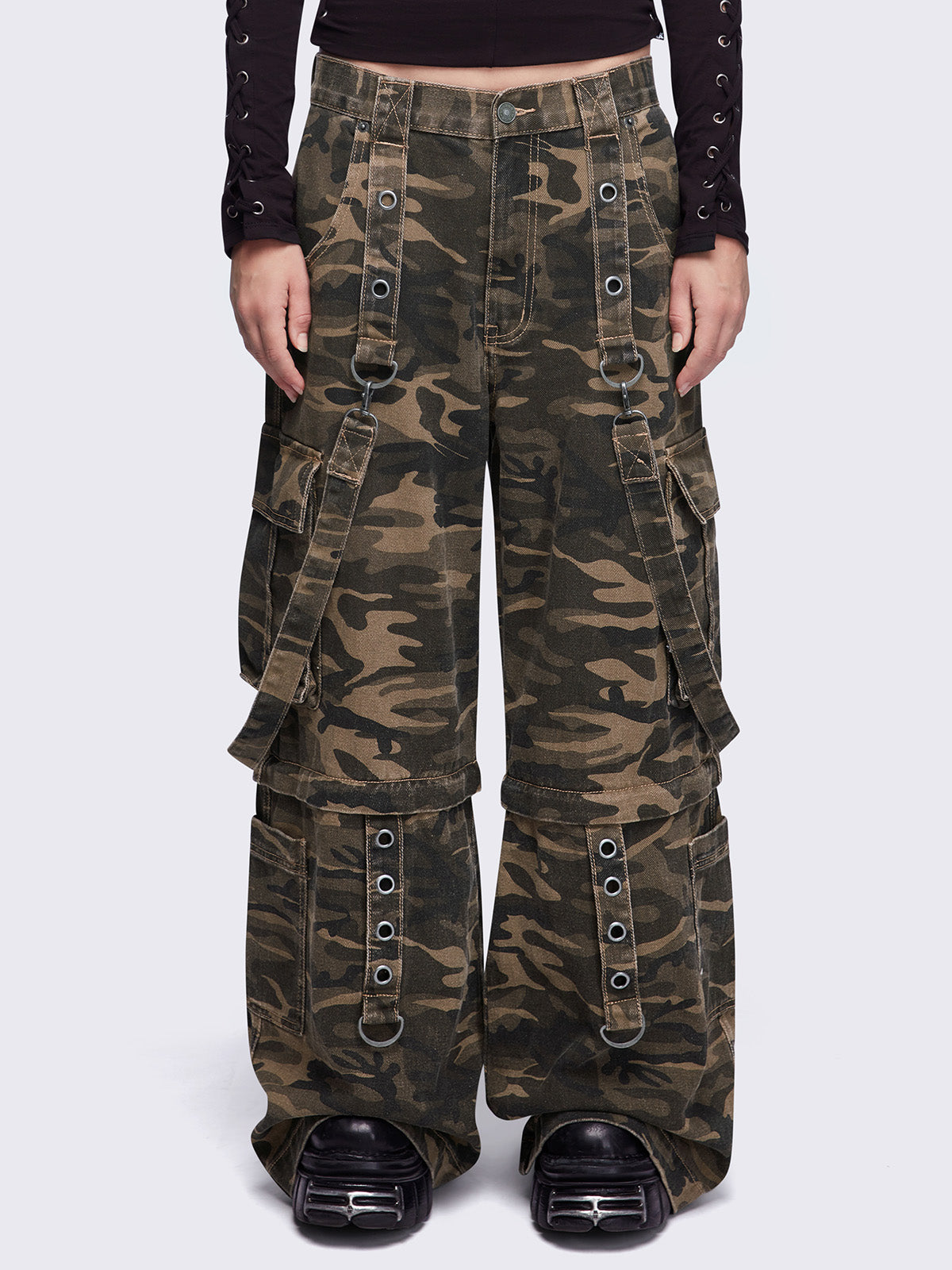 Camo multi pocket cargo jeans featuring a detachable-leg with zipper and all over straps and D-rings details.