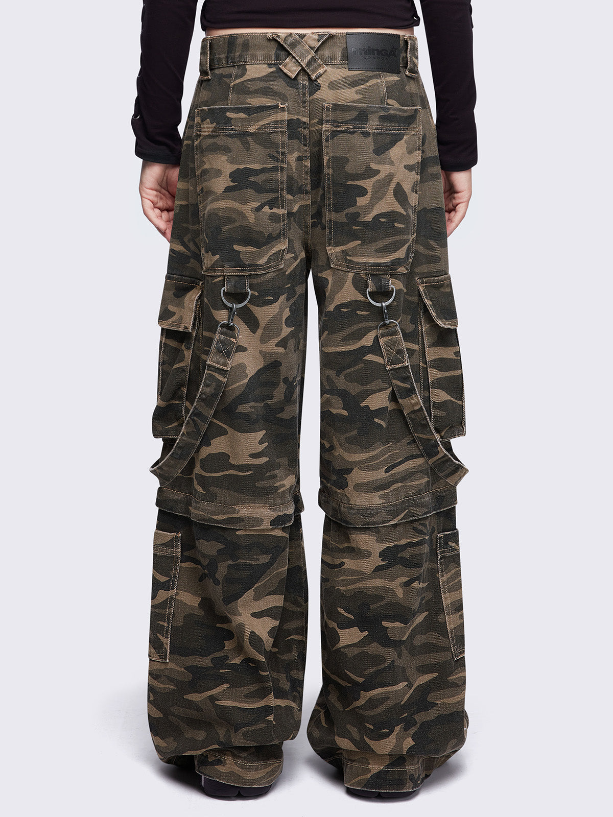 Camo multi pocket cargo jeans featuring a detachable-leg with zipper and all over straps and D-rings details.