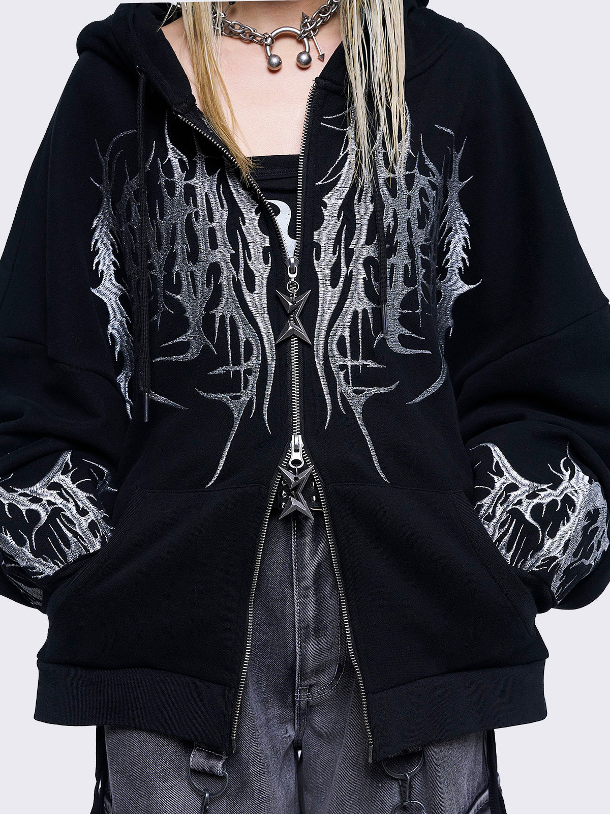 Black zip up hoodie jacket featuring a grey sigilism embroidery on front and sleeves and a oversized fit. 