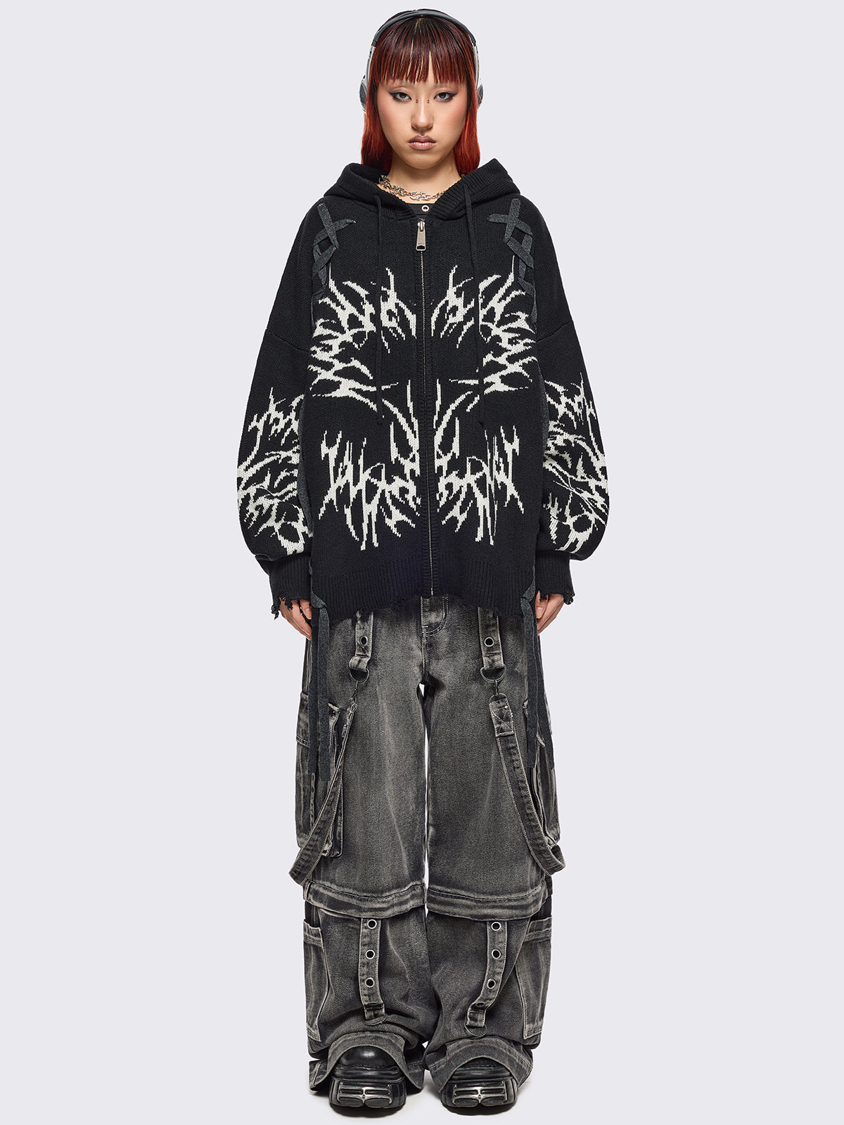 Black hooded chunky knit cardigan featuring white sigilism graphic design, contrast grey lace up details and distressed trims.