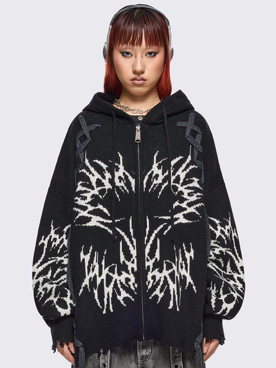 Black hooded chunky knit cardigan featuring white sigilism graphic design, contrast grey lace up details and distressed trims.