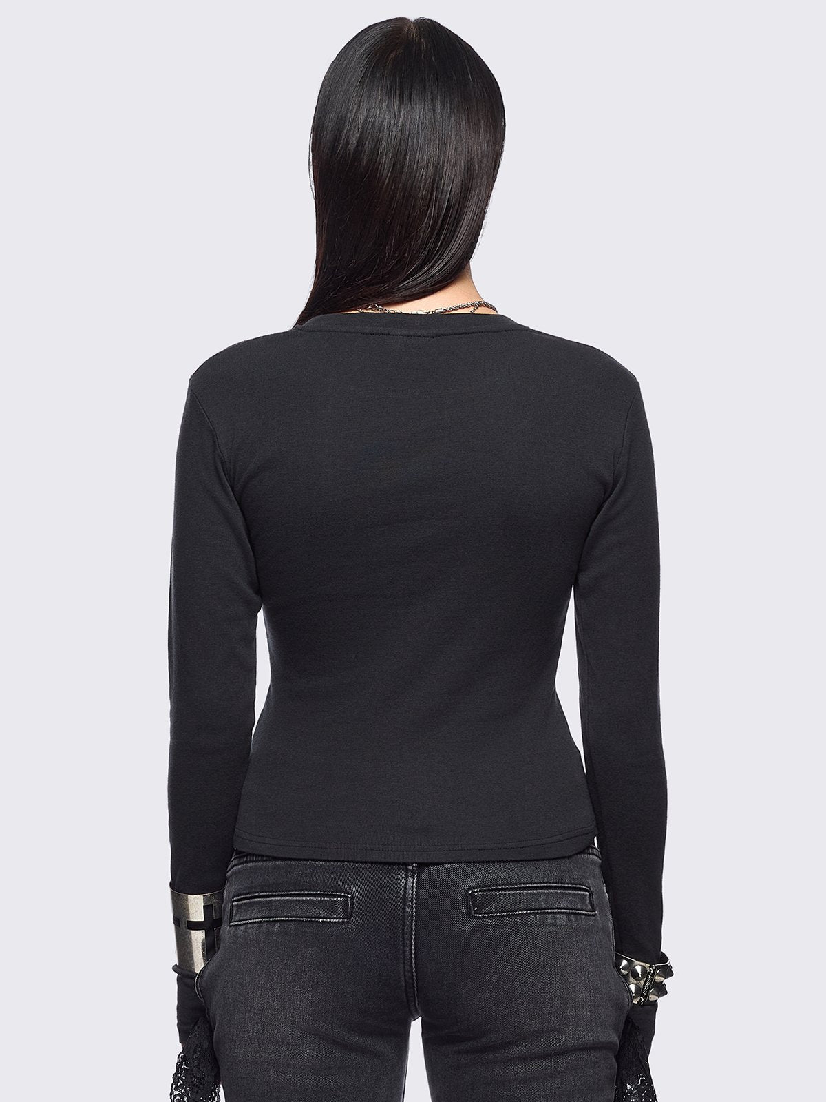 Black long sleeve top featuring an angelic wings graphic front print.