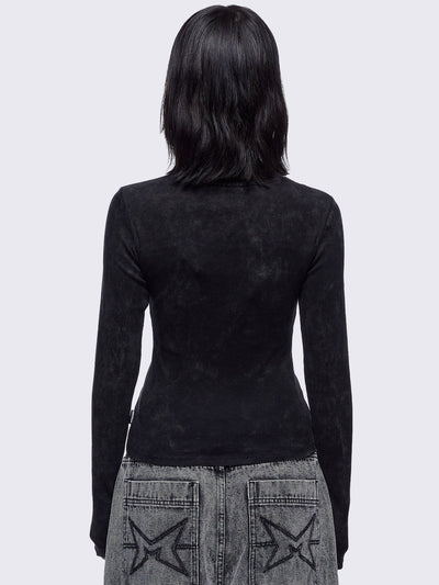 Black washed asymmetric top with cut-out and safety pin details.