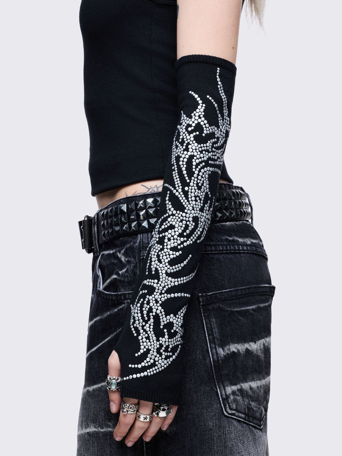 Black knitted arm warmers with sigilism design with hot fix studs.