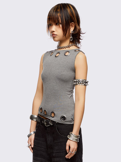 Grey asymmetric top featuring chunky eyelets along neckline and hem and boat neckline.