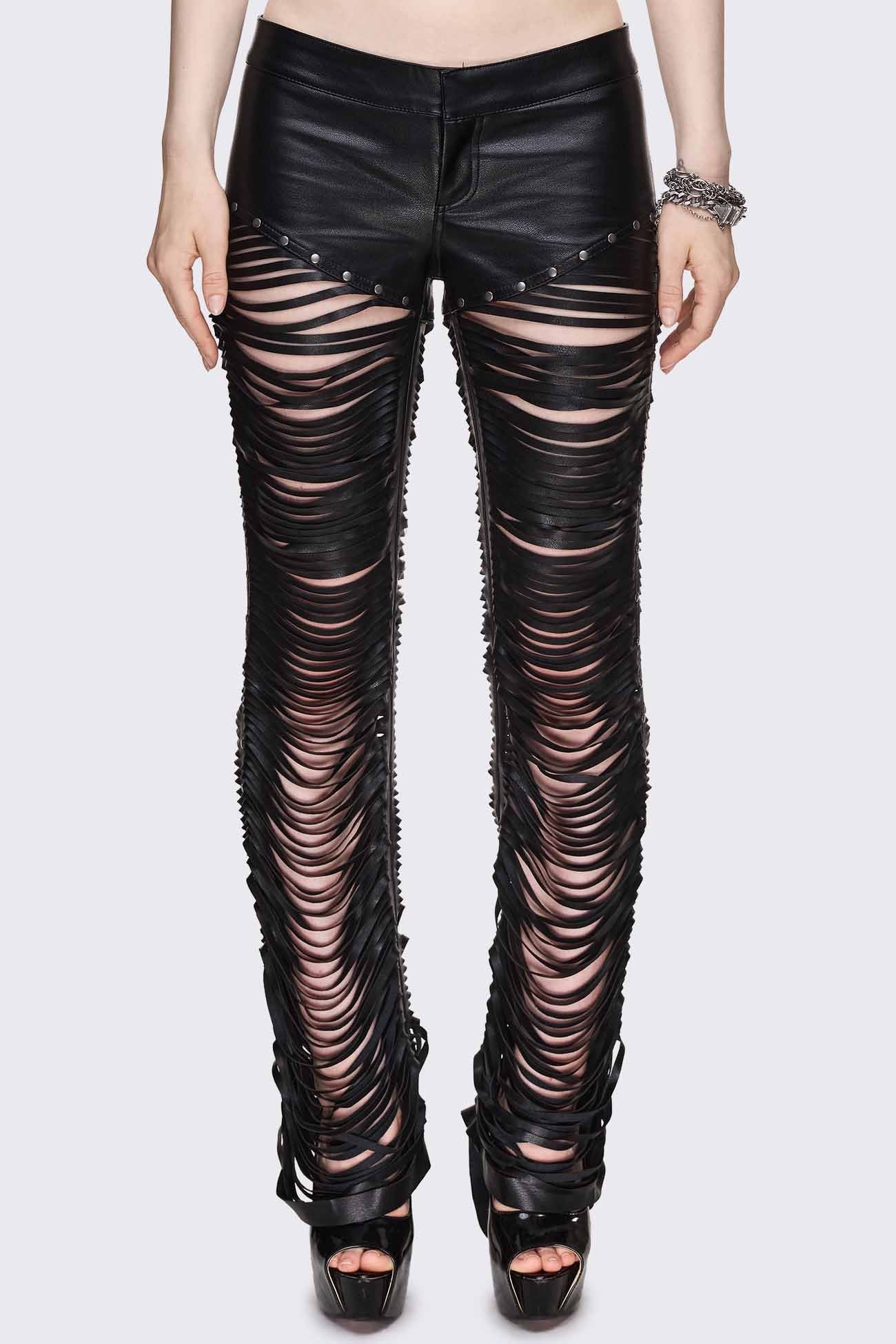 Black faux leather flared pants with shredded slash legs, silver-tone stud trim and low-rise waist.