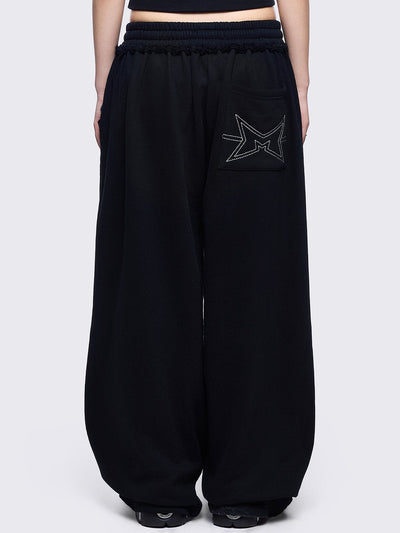 Black sweatpants with white chunky cross patches