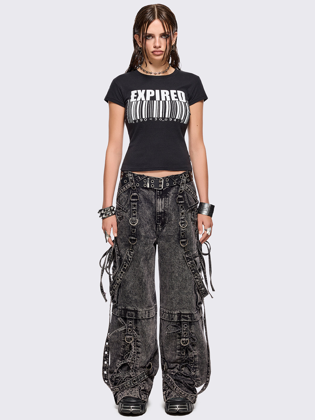 Grey acid washed multi pocket cargo jeans featuring a detachable-leg with zipper and all over strap, D-ring and lace up details.