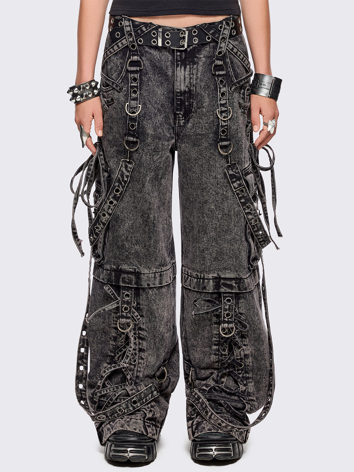 Grey acid washed multi pocket cargo jeans featuring a detachable-leg with zipper and all over strap, D-ring and lace up details.