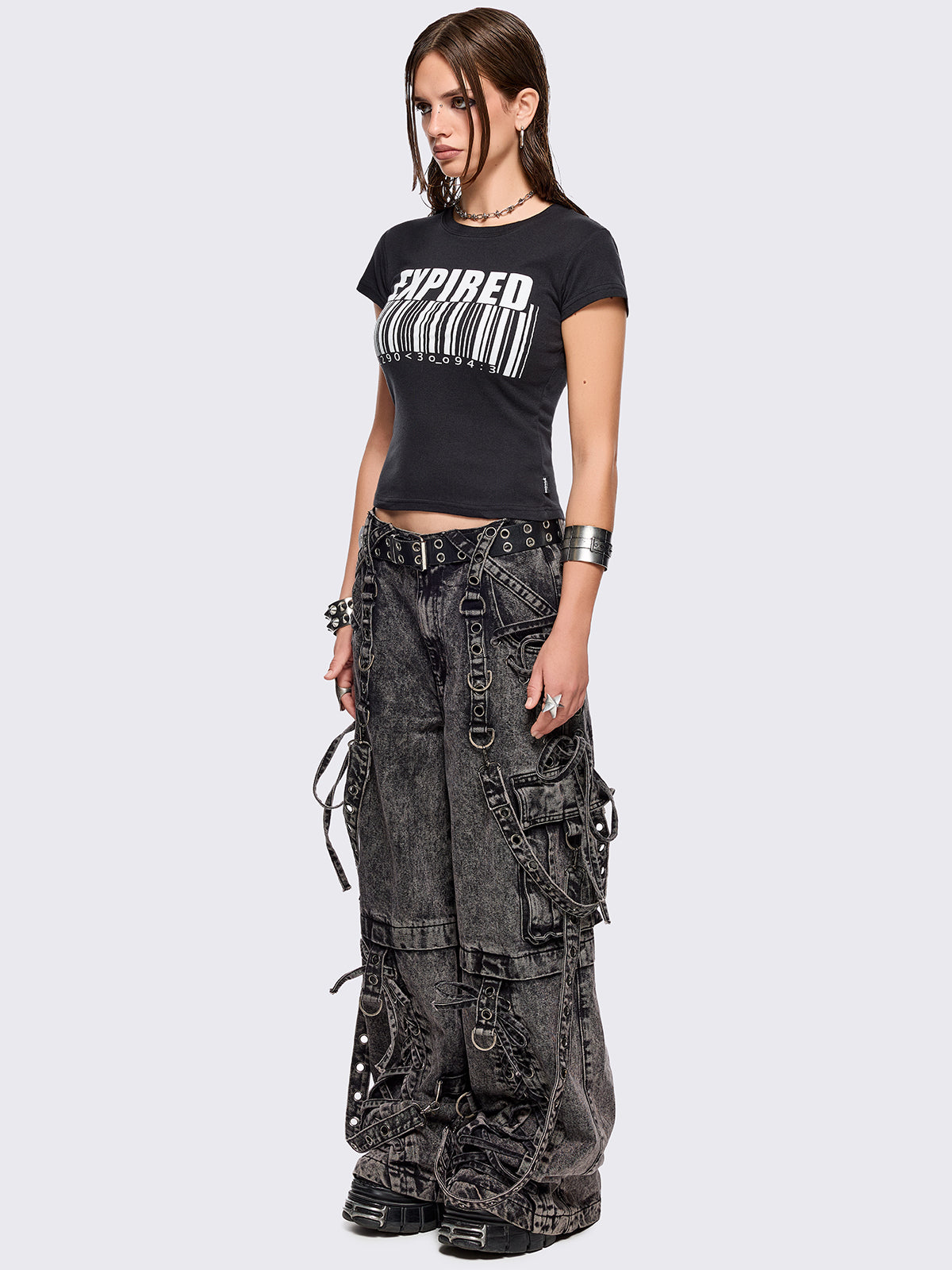 Grey acid washed multi pocket cargo jeans featuring a detachable-leg with zipper and all over strap, D-ring and lace up details.