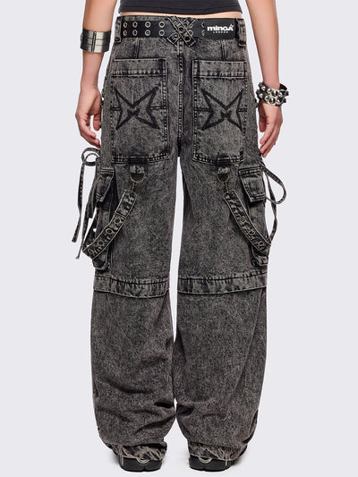 Grey acid washed multi pocket cargo jeans featuring a detachable-leg with zipper and all over strap, D-ring and lace up details.