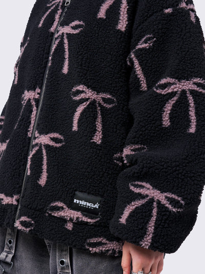 Black borg fleece hoodie jacket with an all-over pink bows design. Features an oversized fit and zip fastening.