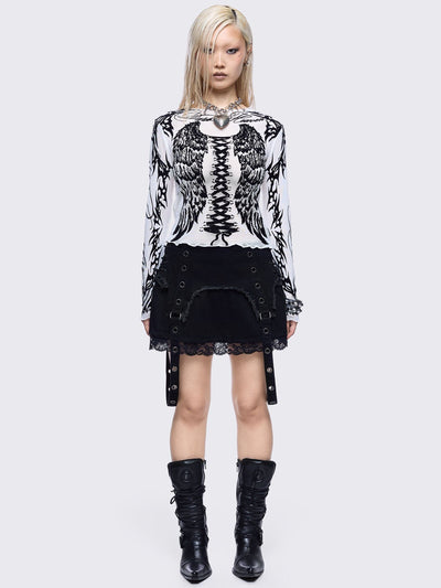 Black denim mini skirt with distressed frayed panels, lace up side details and eyelet straps.