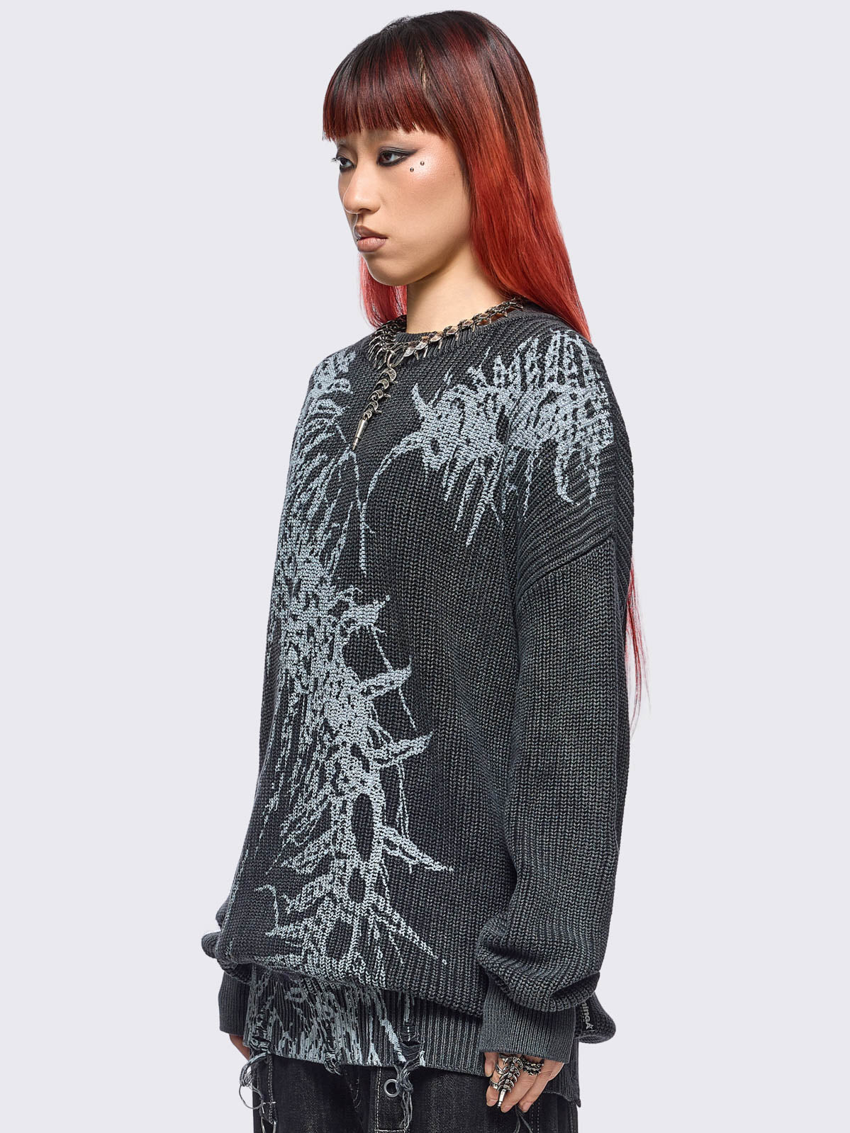 Black washed knit jumper in chunky ribbed knit with centipede graphic front print and distressed hem details. 