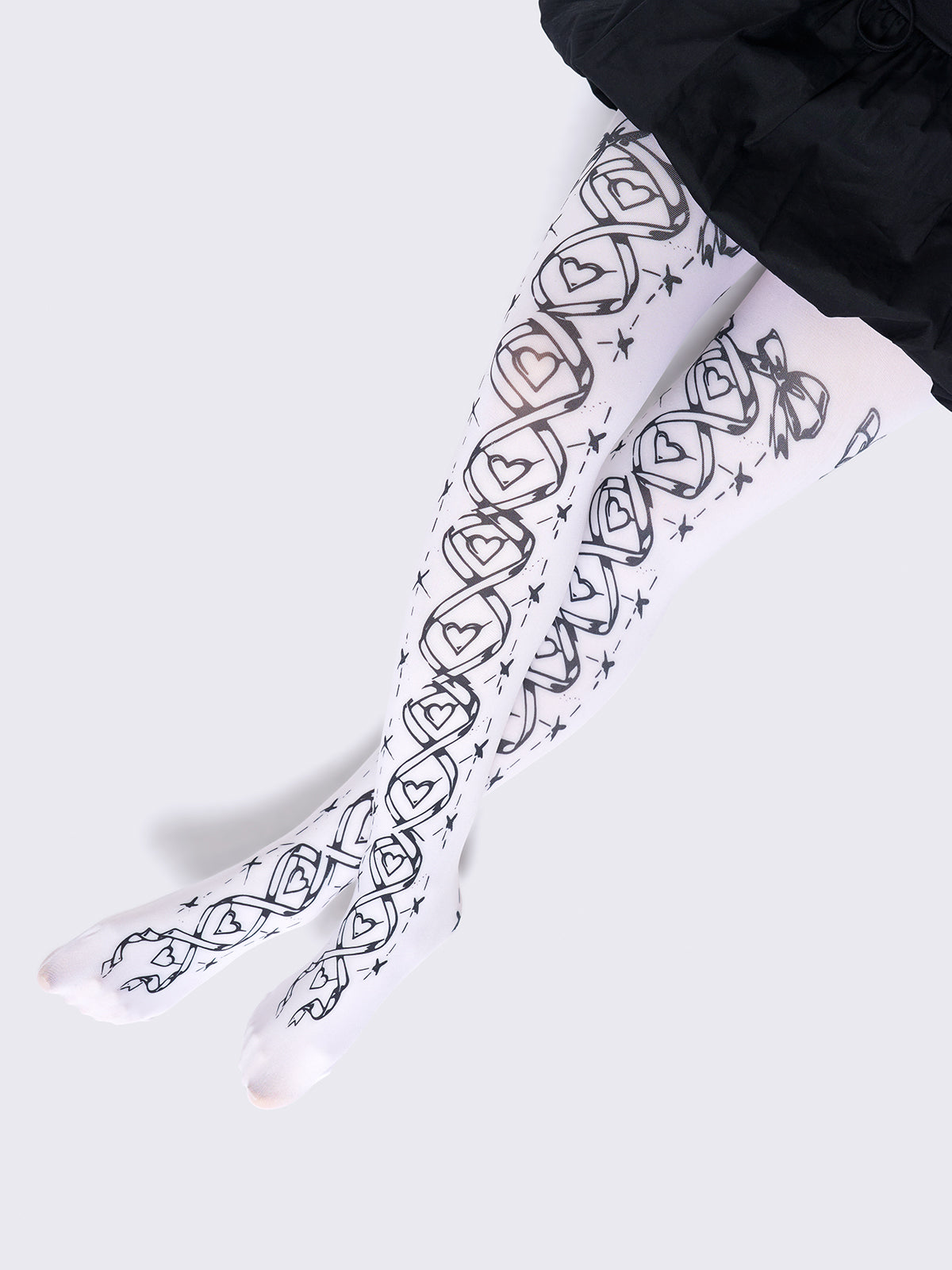 Opaque tights in white with black lace-up corset print.