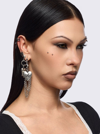 Silver 4pc layering earring set featuring heart and tooth pendant in chunky hoops, studs and ear cuff style.