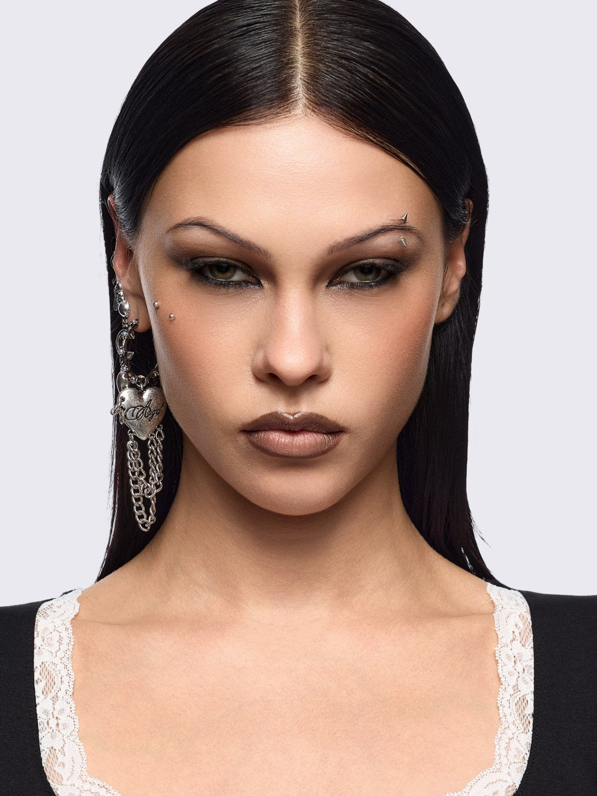 Silver 4pc layering earring set featuring heart and tooth pendant in chunky hoops, studs and ear cuff style.