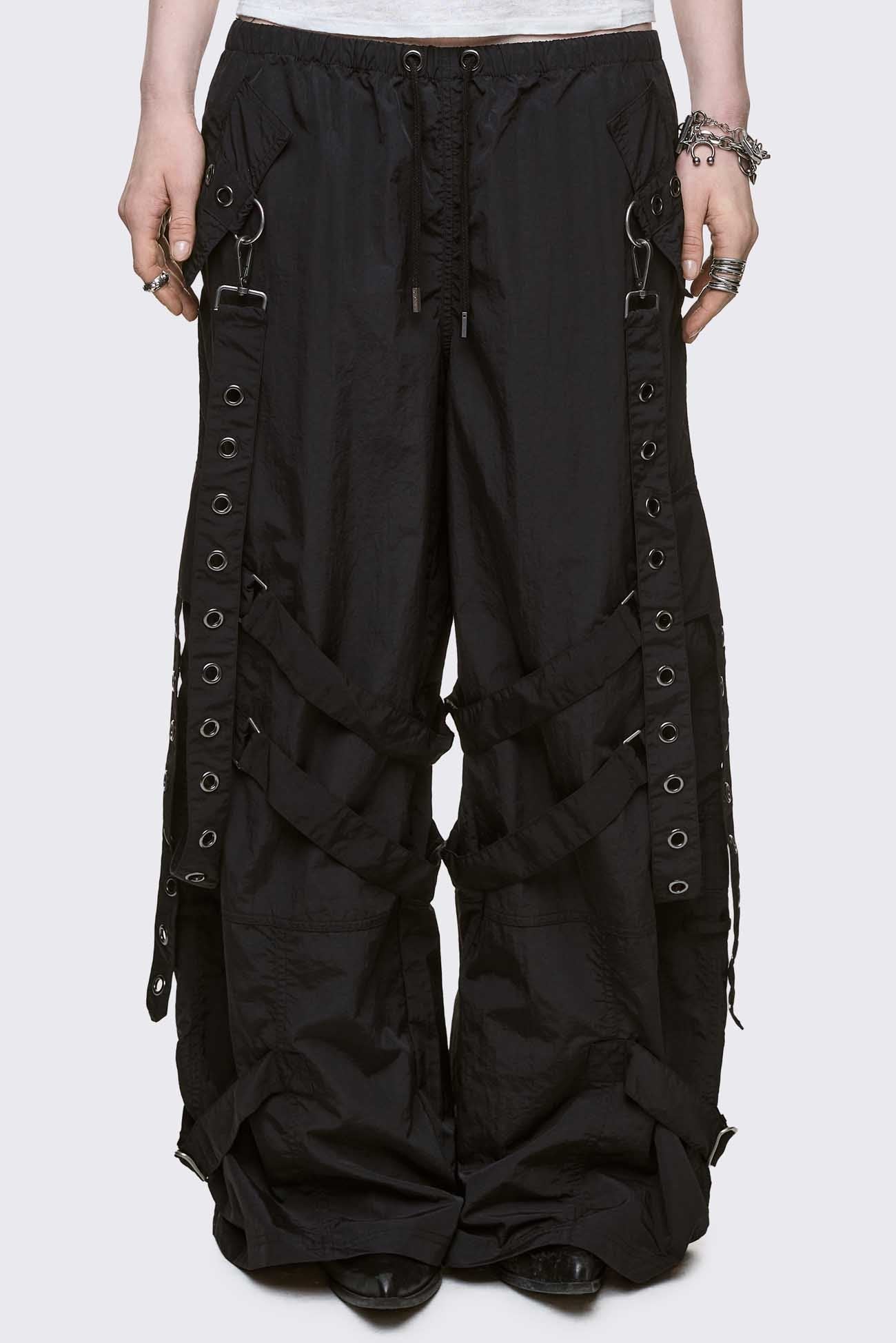 Black tech parachute cargo pants with all over straps, hardware details and utility pockets. 