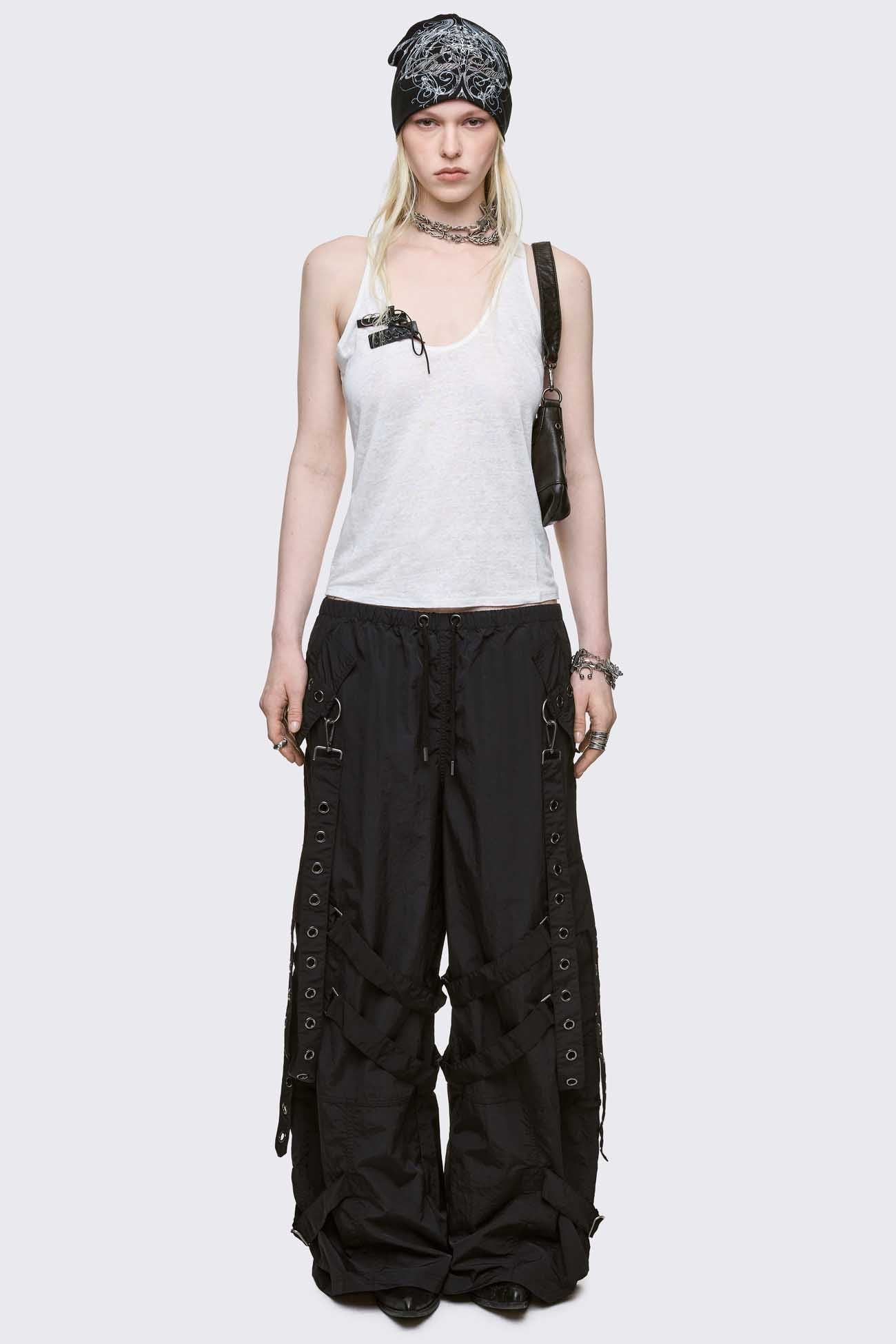 Black tech parachute cargo pants with all over straps, hardware details and utility pockets. 