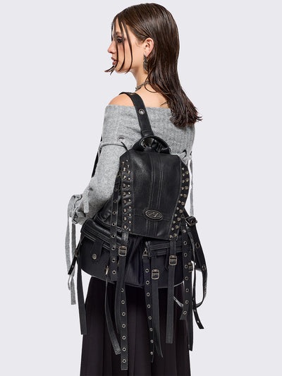 Black vegan leather backpack featuring silver stud, eyelet and strap details.
