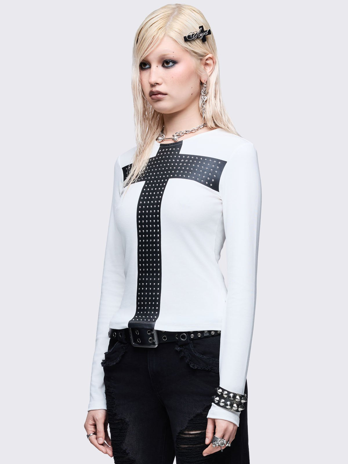 White long sleeve top with black chunky cross with silver studs