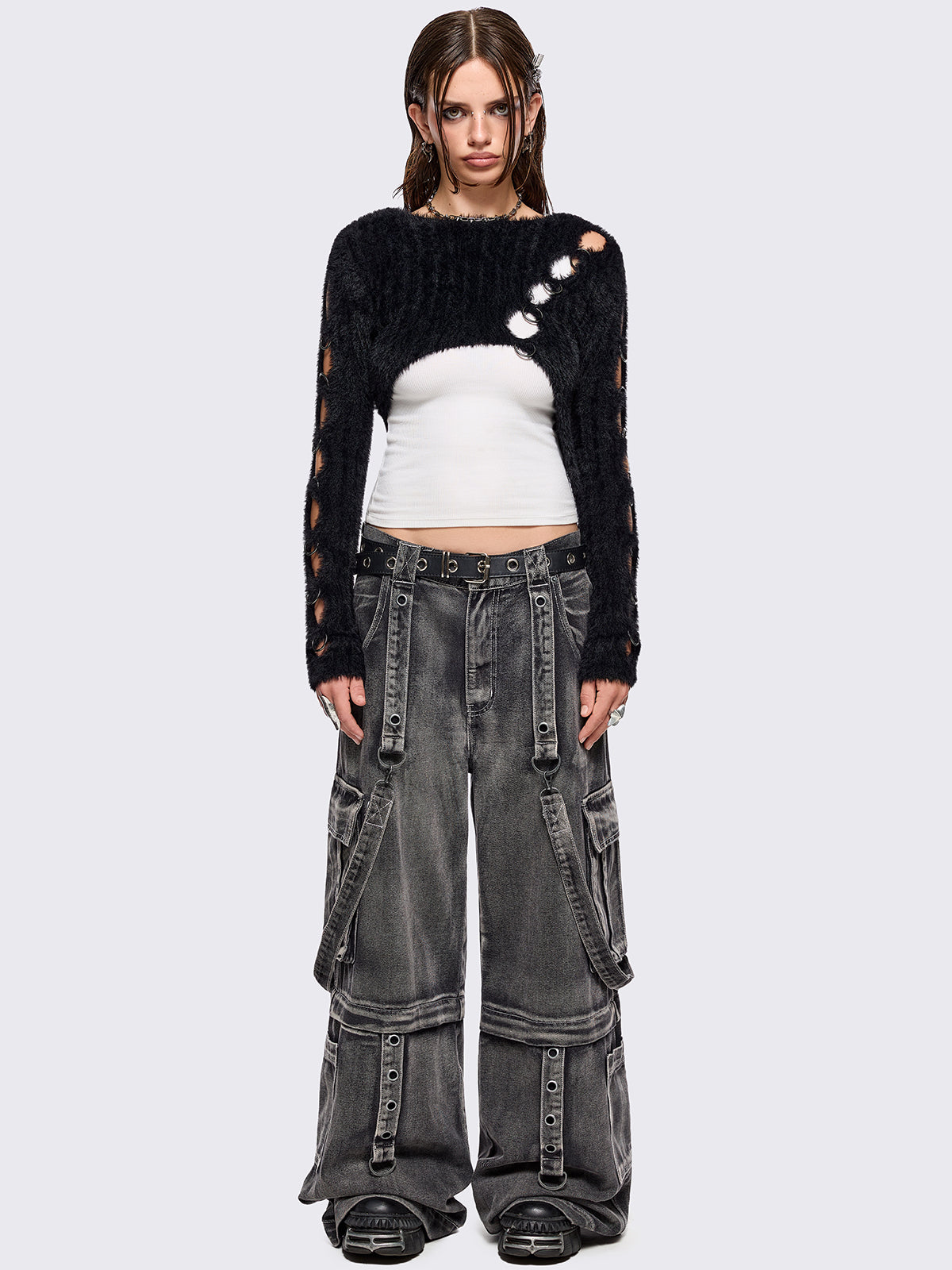 Black fuzzy knitted sweater with cut-outs with metal ring hardware details.
Bolero asymmetric style.