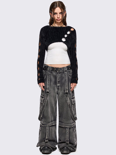 Black fuzzy knitted sweater with cut-outs with metal ring hardware details.
Bolero asymmetric style.