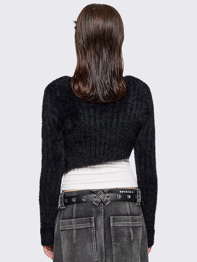 Black fuzzy knitted sweater with cut-outs with metal ring hardware details.
Bolero asymmetric style.