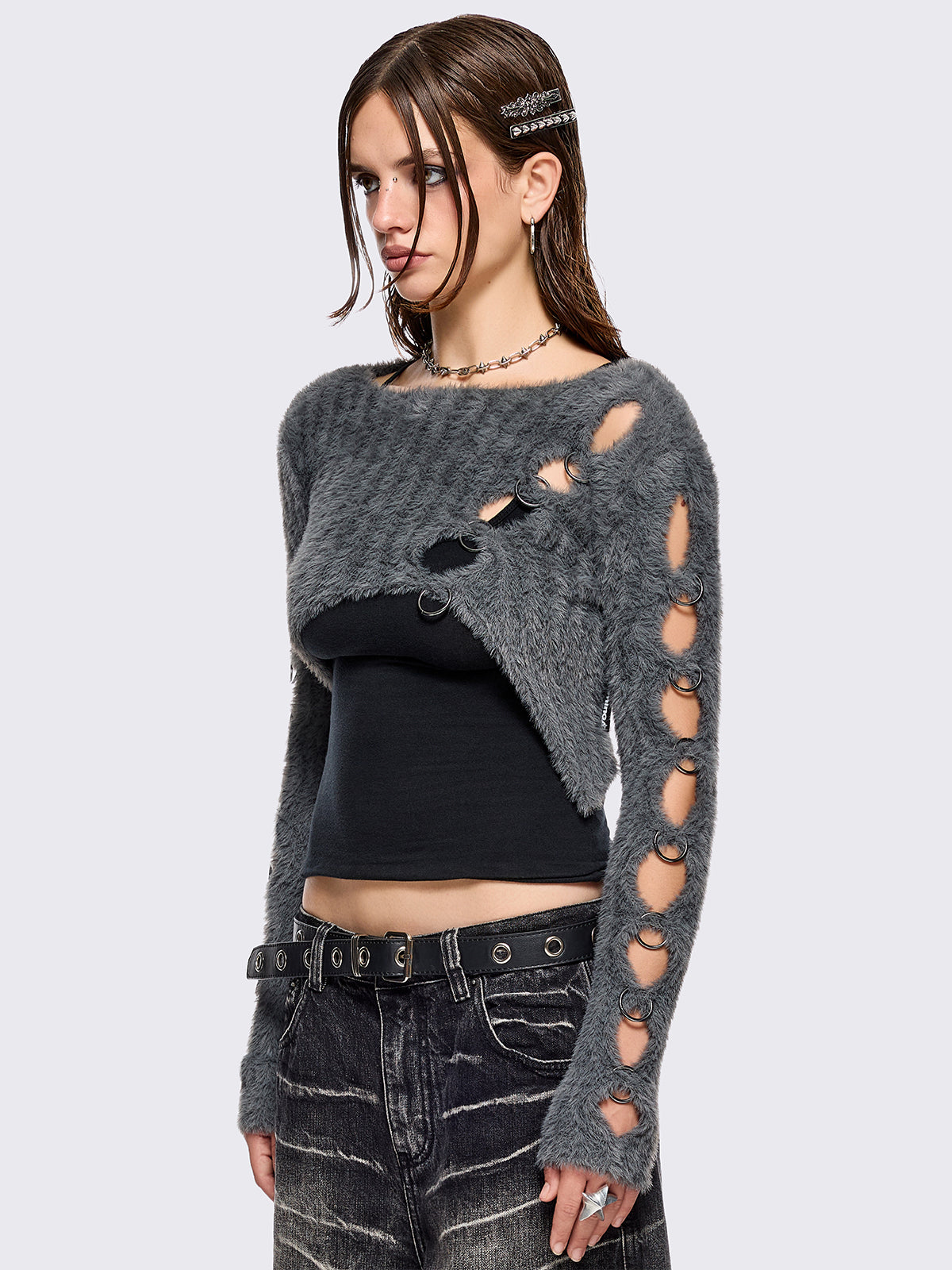 Grey fuzzy knitted sweater with cut-outs with metal ring hardware details.
Bolero asymmetric style.