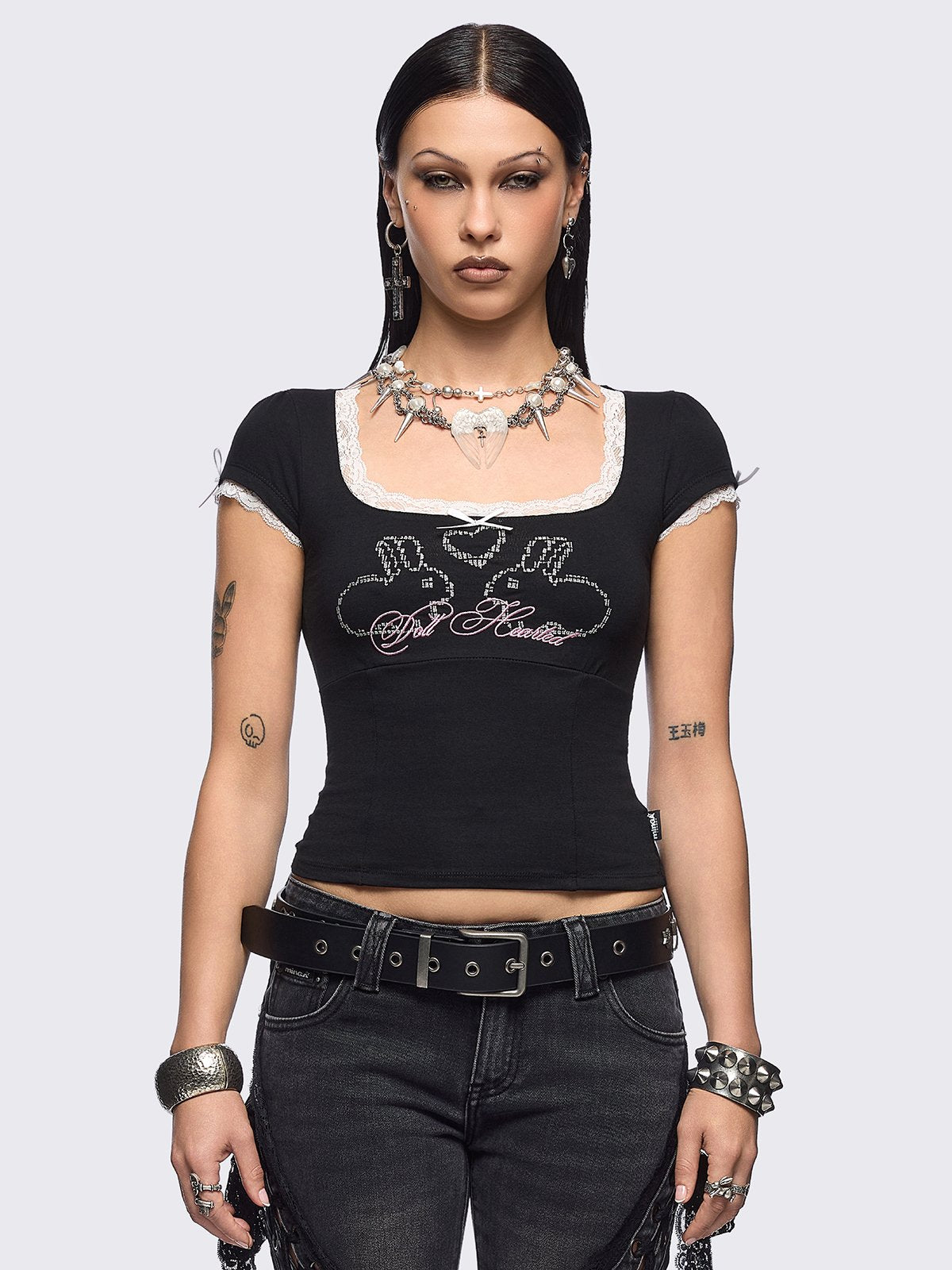 Black baby tee with "Doll Hearted" and bunnies graphic embroidery, white lace at seams and bow details.