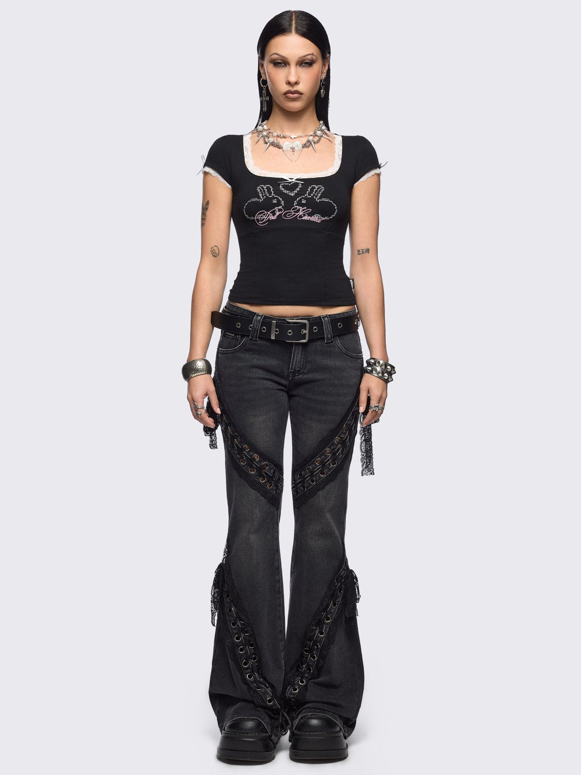 Black washed flare jeans with lace up bow details.