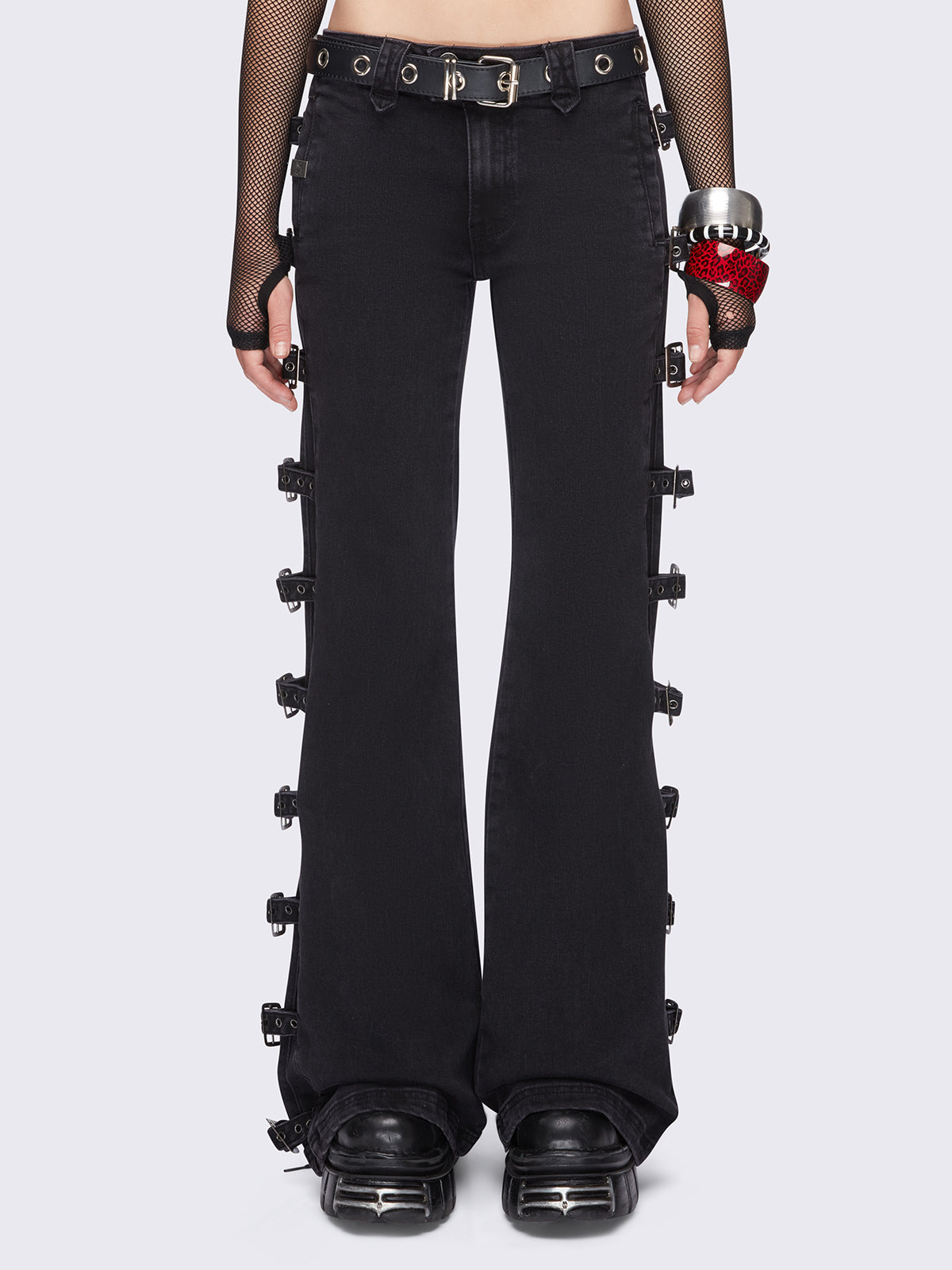 Black flared jeans with buckle details on side and low waist.