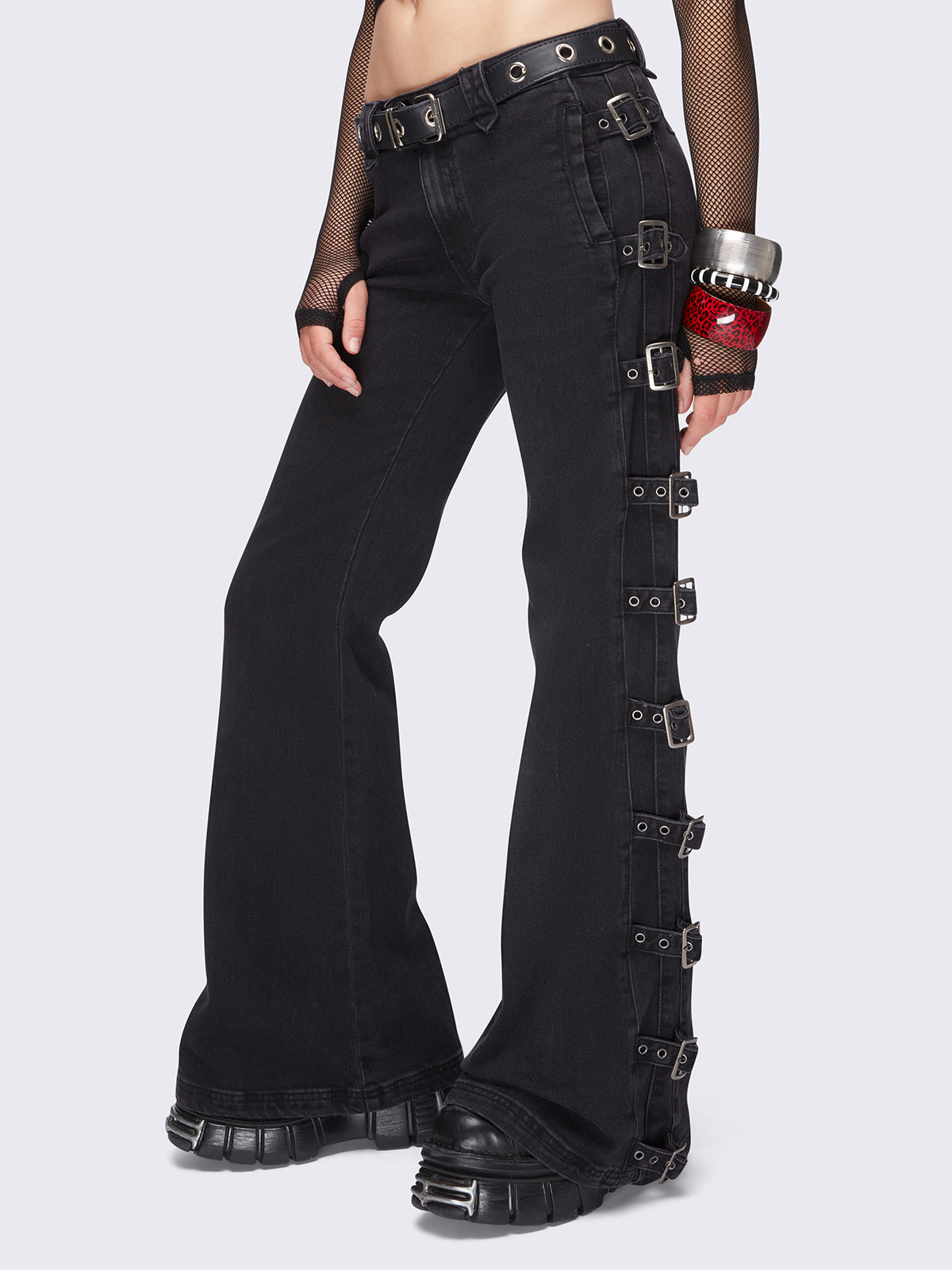 Black flared jeans with buckle details on side and low waist.