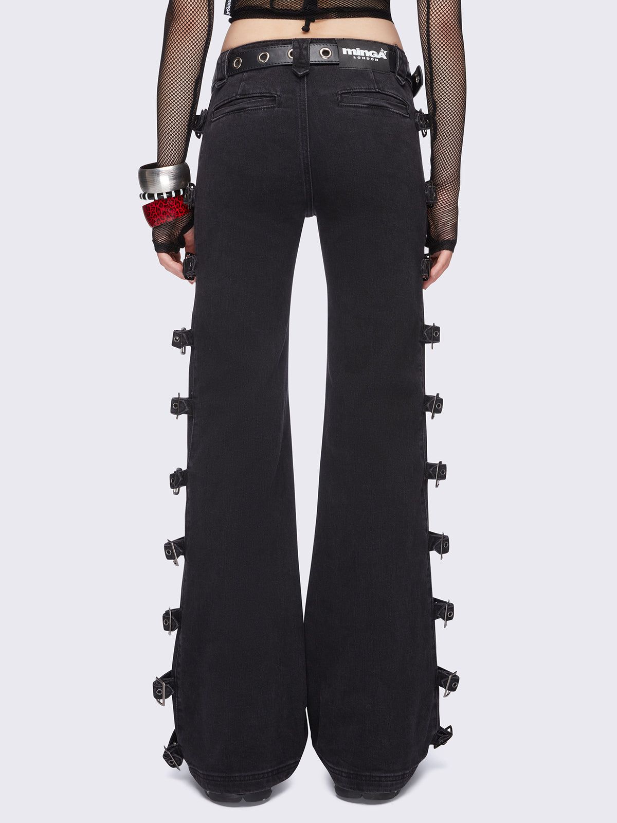 Black flared jeans with buckle details on side and low waist.