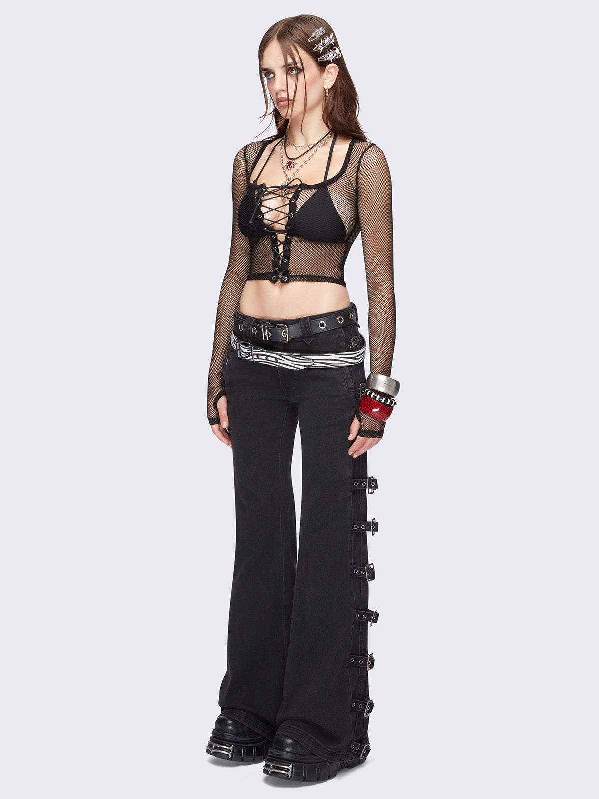 Black flared jeans with buckle details on side and low waist.