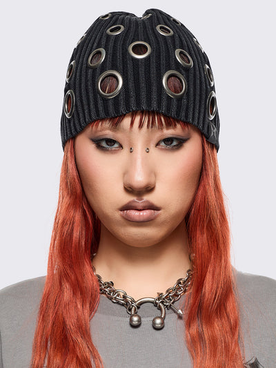 Black ribbed knit beanie with chunky silver eyelets.