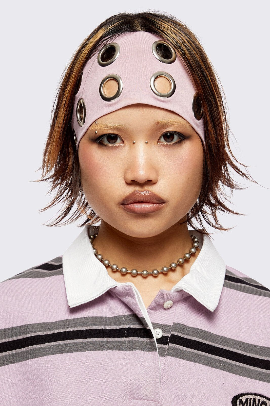 Headband in baby pink with chunky silver eyelets. 