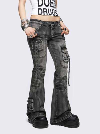 Black washed cargo flared jeans with utility pockets and straps.