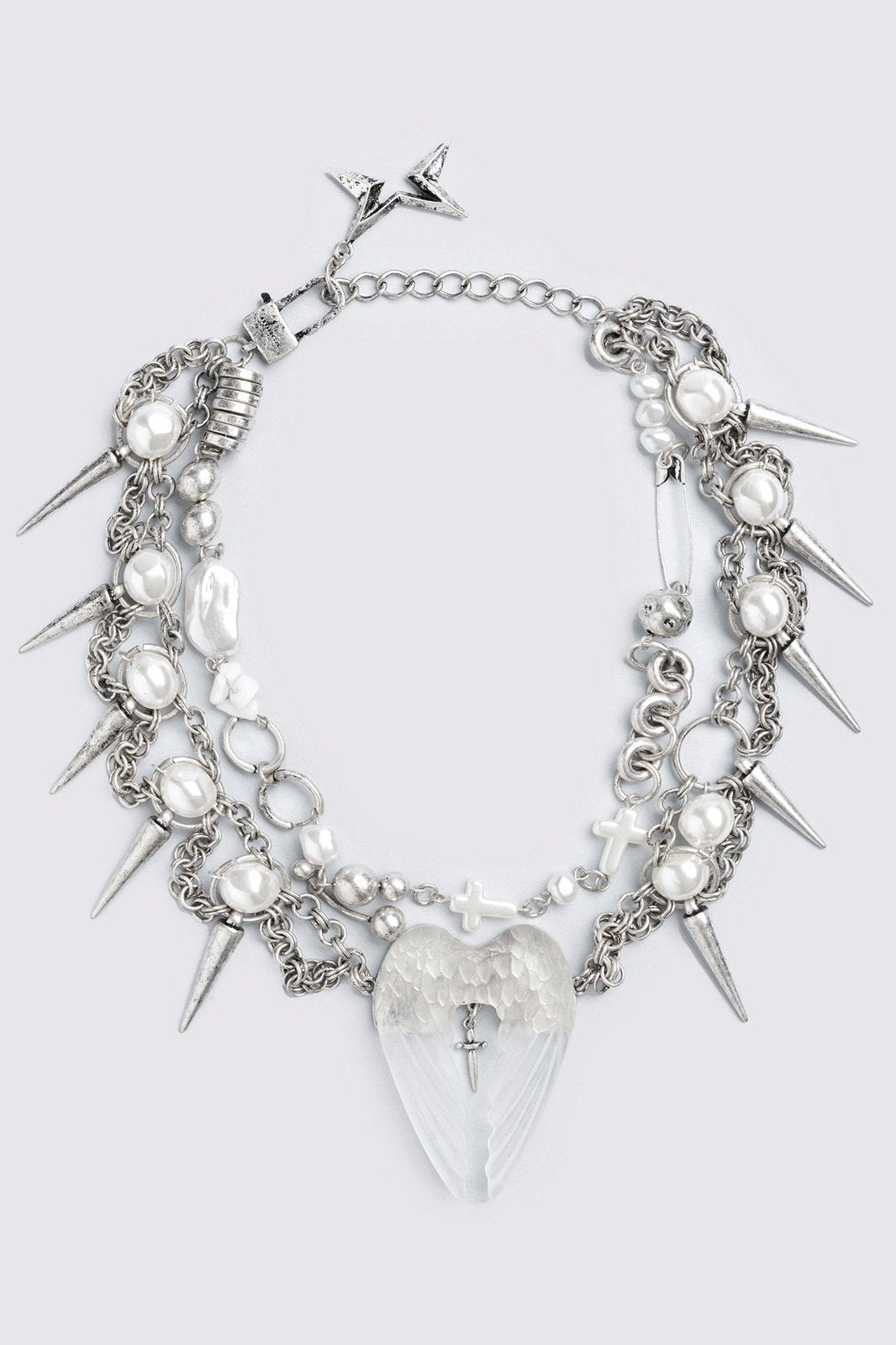 Chunky silver charm necklace with spike, pearl, piercing and cross details and a chunky angel wings pendant.