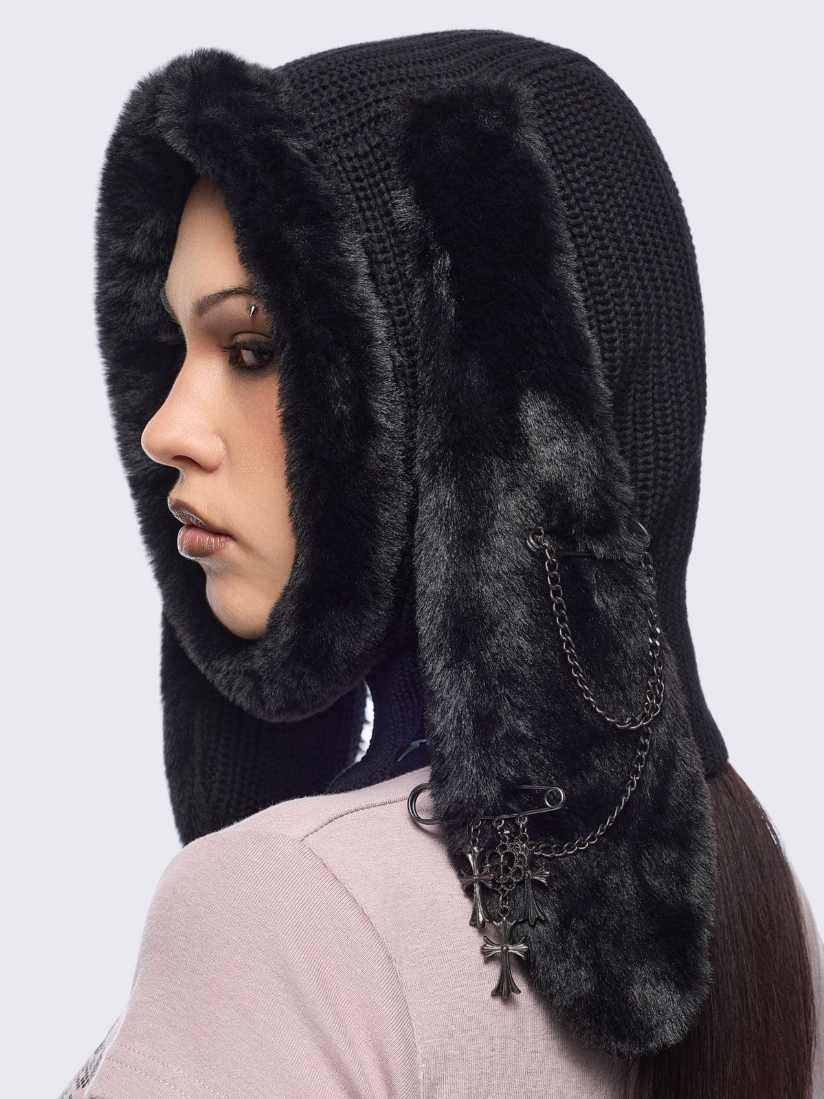 Black knitted balaclava with faux fur floppy ears with chains, safety pins and cross pendants.