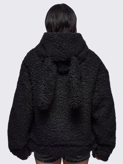 Black faux fur coat featuring a bunny ear hood and faux leather details with silver studs.