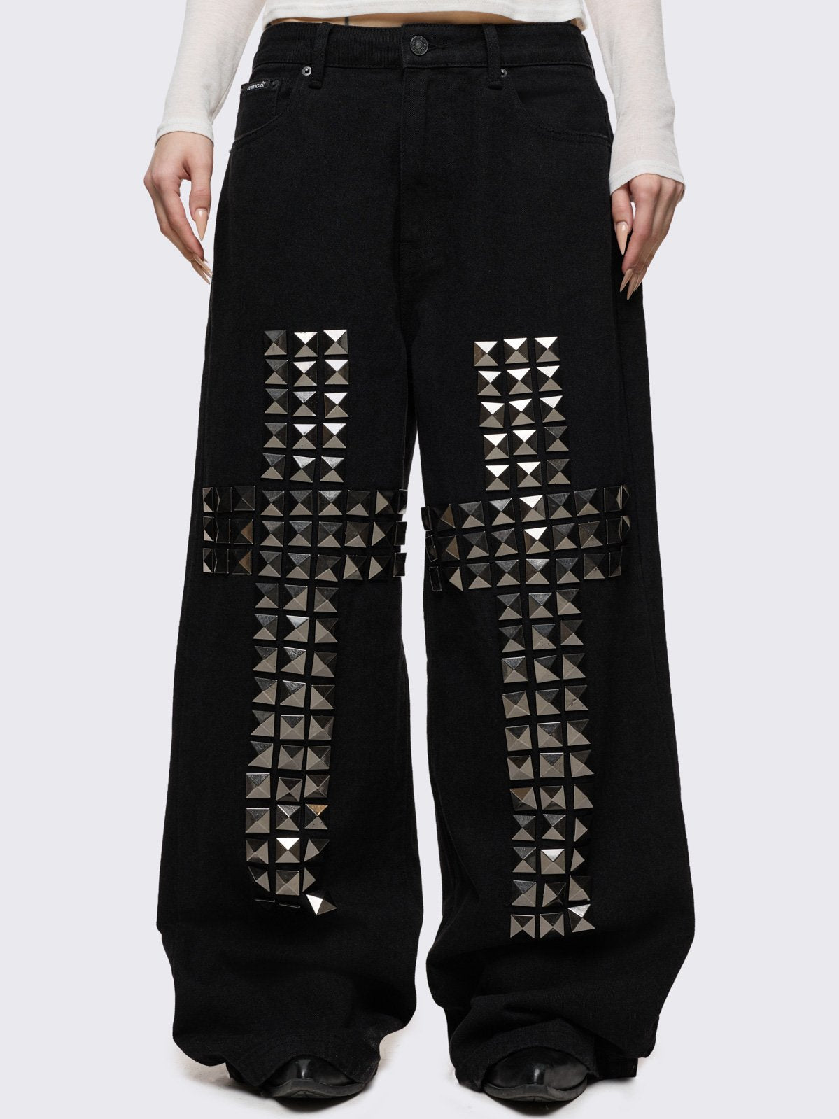 Black baggy jeans with silver studded crosses.