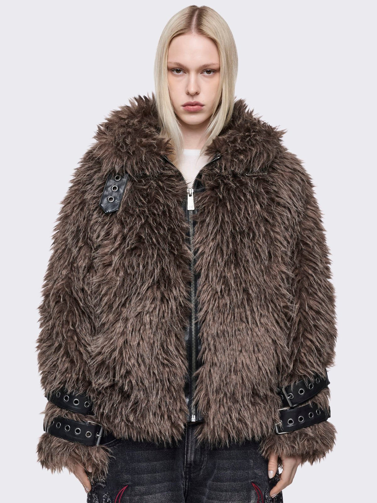 Voluminous oversized brown faux fur jacket featuring long-pile shaggy texture and a high-neck funnel collar.