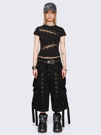 Black baby tee with diagonal fishnet cut-outs, eyelet and chain lace-up details, and short sleeves.