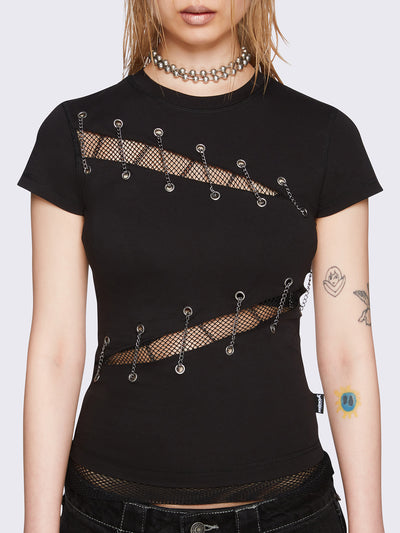 Black baby tee with diagonal fishnet cut-outs, eyelet and chain lace-up details, and short sleeves.