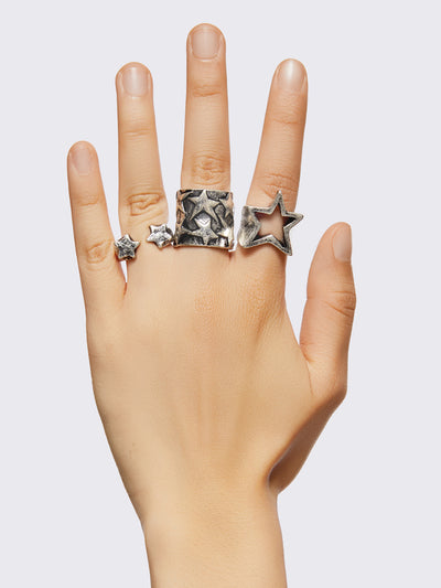 Set of 6 silver chunky rings with multiple star designs.