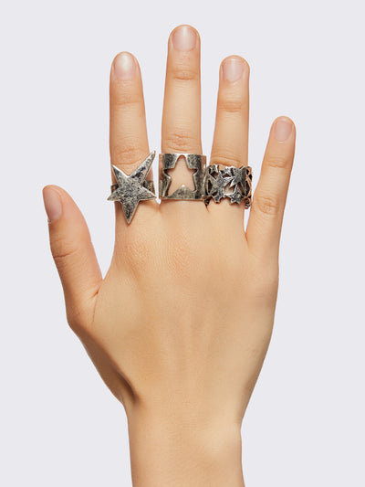 Set of 6 silver chunky rings with multiple star designs.