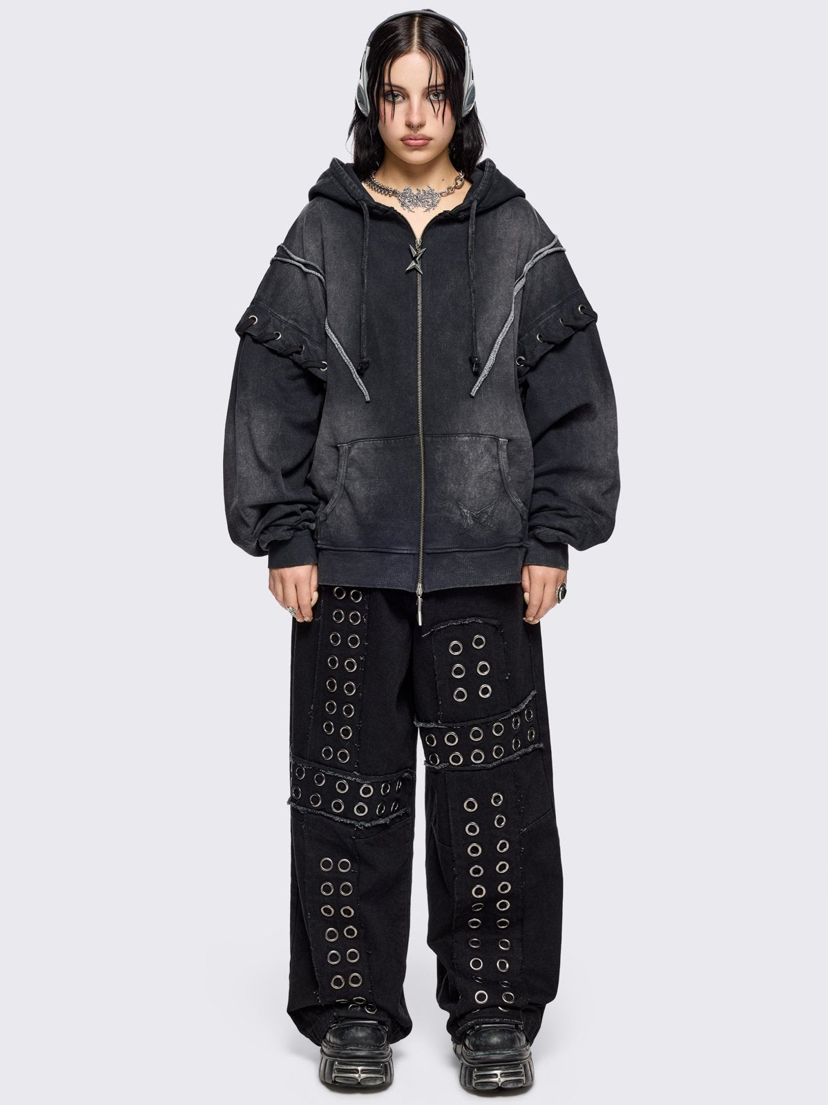 Black washed zip up hoodie. Featuring a layered effect, with selver eyelets, lace ups and seams details. 